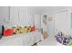 Inviting bedroom with a daybed adorned with decorative pillows and view of the staircase through an open door at 1415 Powhaton Dr., Myrtle Beach, SC 29577