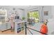 Bright bedroom featuring a comfortable daybed, a well-organized craft desk, and a sliding glass door leading to an outdoor area at 1415 Powhaton Dr., Myrtle Beach, SC 29577