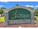 Community sign reads 'The Cottages on Farrow Parkway' with natural stone accents at 1415 Powhaton Dr., Myrtle Beach, SC 29577