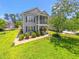 Exterior of home showing a well-manicured lawn, neatly trimmed shrubbery, and an inviting screened in porch at 1415 Powhaton Dr., Myrtle Beach, SC 29577