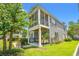 Exterior view of a two-story home showcasing a screened porch and well-maintained landscaping at 1415 Powhaton Dr., Myrtle Beach, SC 29577