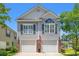 Charming two-story home featuring a double garage, and an inviting front yard at 1415 Powhaton Dr., Myrtle Beach, SC 29577