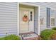 Attractive front entrance with a glass door, a welcoming wreath, and neat landscaping at 1415 Powhaton Dr., Myrtle Beach, SC 29577