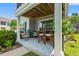 Charming covered patio with outdoor seating, patterned floor, and lush landscaping at 1415 Powhaton Dr., Myrtle Beach, SC 29577