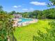 Community swimming pool features a pool house, several lounge chairs and umbrellas at 1415 Powhaton Dr., Myrtle Beach, SC 29577