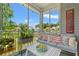 Cozy screened porch with comfortable furniture, string lights, and peaceful outdoor scenery at 1415 Powhaton Dr., Myrtle Beach, SC 29577