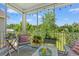 Relaxing screened porch with comfortable seating, string lights, and view of landscaped yard at 1415 Powhaton Dr., Myrtle Beach, SC 29577