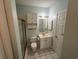 Bathroom with shower stall, toilet, vanity with storage cabinet, mirror, and tiled floor at 1514 Lanterns Rest Dr. # 103, Myrtle Beach, SC 29579