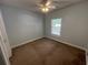 Carpeted bedroom with light green walls and a window at 1514 Lanterns Rest Dr. # 103, Myrtle Beach, SC 29579