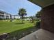 A serene exterior view shows a lush lawn and distant buildings with a clear blue sky at 1514 Lanterns Rest Dr. # 103, Myrtle Beach, SC 29579