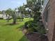 Well-manicured lawn with palm trees and lush bushes adjacent to a brick building at 1514 Lanterns Rest Dr. # 103, Myrtle Beach, SC 29579