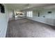 Open living area with carpet, mirrored wall, and view of the kitchen at 1514 Lanterns Rest Dr. # 103, Myrtle Beach, SC 29579