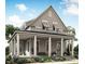Charming two-story home featuring a welcoming front porch with classic columns and a well-manicured lawn at 1627 Sayebrook Pkwy., Myrtle Beach, SC 29588