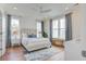 Bright primary bedroom with a comfortable bed, stylish furnishings, and ample natural light from the large windows at 1627 Sayebrook Pkwy., Myrtle Beach, SC 29588