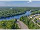 Aerial view showcases the community's waterfront access, boat ramp, and proximity to a wide, winding river at 1725 Boyne Dr., Myrtle Beach, SC 29588