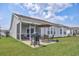 A covered back patio features outdoor seating and a grill, perfect for outdoor dining and relaxation at 1725 Boyne Dr., Myrtle Beach, SC 29588