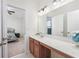 Bright bathroom features a large vanity with white countertop and cherry-wood cabinets at 1725 Boyne Dr., Myrtle Beach, SC 29588