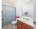 Inviting bathroom features patterned shower curtain, tile flooring, and vanity with countertop sink at 1725 Boyne Dr., Myrtle Beach, SC 29588