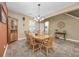 Dining room featuring natural wood table and chairs beneath a chandelier, with tile flooring and warm neutral paint at 1725 Boyne Dr., Myrtle Beach, SC 29588