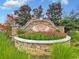Beautiful stone entrance sign for Cameron Village surrounded by colorful flowers and lush greenery at 1725 Boyne Dr., Myrtle Beach, SC 29588