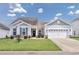 Charming single-story home with a well-maintained lawn, inviting curb appeal, and an attached two car garage at 1725 Boyne Dr., Myrtle Beach, SC 29588