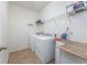 Bright laundry room with tile flooring and a washer and dryer, featuring ample shelving at 1725 Boyne Dr., Myrtle Beach, SC 29588