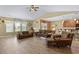 Cozy living room featuring a ceiling fan, hardwood floors, and a comfortable seating arrangement with natural light at 1725 Boyne Dr., Myrtle Beach, SC 29588