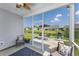 View from screened porch with comfortable seating, overlooking water feature and neighboring yards at 1725 Boyne Dr., Myrtle Beach, SC 29588