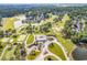 Aerial view of a beautiful community featuring lovely homes, a golf course, a lake, and mature trees at 1788 Club Circle, Pawleys Island, SC 29585