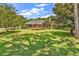 A serene backyard with a well-manicured lawn and a cozy patio area perfect for outdoor entertaining at 1788 Club Circle, Pawleys Island, SC 29585