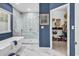 Stylish bathroom showcasing a sleek tub, glass shower, and blue accent wall at 1788 Club Circle, Pawleys Island, SC 29585