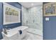 Bright bathroom featuring a freestanding tub, glass shower and blue walls at 1788 Club Circle, Pawleys Island, SC 29585