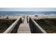 A walkway leads to a stunning beach, providing easy access for relaxing and enjoying the ocean views at 1788 Club Circle, Pawleys Island, SC 29585