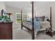 Inviting bedroom featuring a four-poster bed, neutral décor, and soft lighting for a restful retreat at 1788 Club Circle, Pawleys Island, SC 29585
