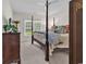 Inviting bedroom featuring a four-poster bed, neutral décor, and soft lighting for a restful retreat at 1788 Club Circle, Pawleys Island, SC 29585