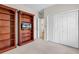 This bedroom features wooden bookshelves with a TV, an open doorway, and white closet doors at 1788 Club Circle, Pawleys Island, SC 29585