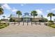 A picturesque clubhouse entrance adorned with palm trees offers a welcoming atmosphere for the community at 1788 Club Circle, Pawleys Island, SC 29585