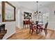 Elegant dining room featuring hardwood floors, traditional chandelier, and large mirror, ideal for entertaining at 1788 Club Circle, Pawleys Island, SC 29585