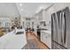 Bright, modern kitchen with white countertops, stainless steel appliances, and hardwood floors at 1788 Club Circle, Pawleys Island, SC 29585