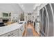 Bright, open kitchen features a long quartz countertop, stainless steel appliances and opens to breakfast nook and living room at 1788 Club Circle, Pawleys Island, SC 29585