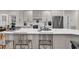 Modern kitchen featuring quartz countertops, stainless steel appliances, and clear acrylic barstools at 1788 Club Circle, Pawleys Island, SC 29585