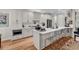 Bright kitchen with white cabinets, quartz countertops, stainless steel appliances, and hardwood floors at 1788 Club Circle, Pawleys Island, SC 29585