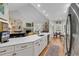Bright, open kitchen features a long quartz countertop, stainless steel appliances and opens to breakfast nook and living room at 1788 Club Circle, Pawleys Island, SC 29585