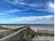 Scenic beach access with wooden walkway leading to the sandy shore and ocean at 18 Canvas Back Cove # 122, Georgetown, SC 29440