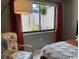 Bright bedroom featuring a comfortable chair with floral pattern and view of outdoor patio at 18 Canvas Back Cove # 122, Georgetown, SC 29440