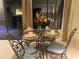 Dining room features a glass table set for four, with iron chairs and garden views at 18 Canvas Back Cove # 122, Georgetown, SC 29440