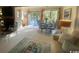 Bright dining area with glass top table and chairs, set near large windows offering views of the outdoors at 18 Canvas Back Cove # 122, Georgetown, SC 29440