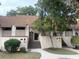 Charming townhome featuring a classic design and inviting front entrance with mature landscaping at 18 Canvas Back Cove # 122, Georgetown, SC 29440