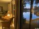 Cozy living room with comfortable seating and a large sliding glass door offering scenic views of the lake at 18 Canvas Back Cove # 122, Georgetown, SC 29440