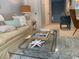 Bright living room with a glass coffee table, neutral walls, and a glimpse of the hallway at 18 Canvas Back Cove # 122, Georgetown, SC 29440